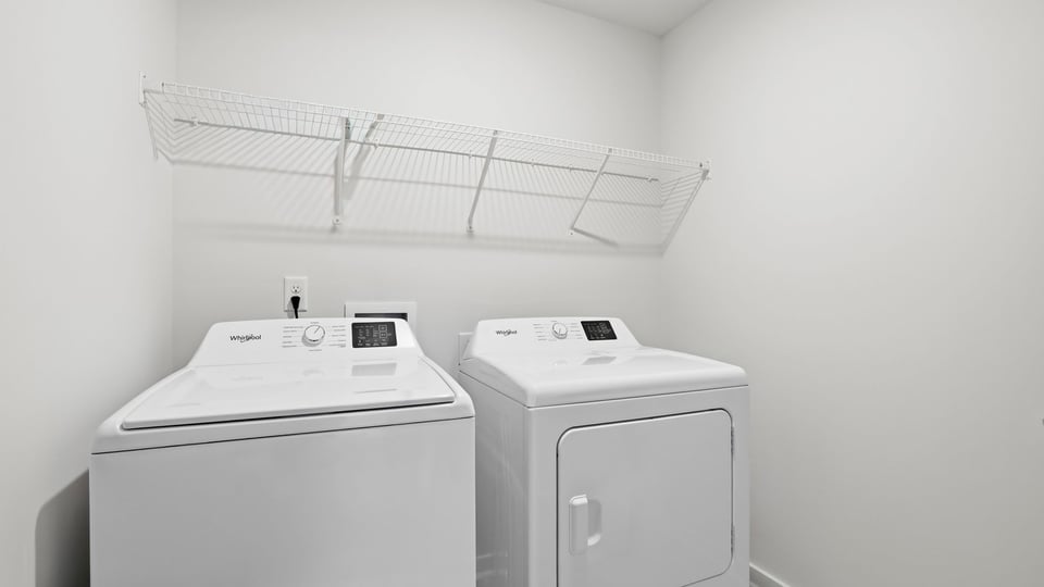 Laundry room with shelf.