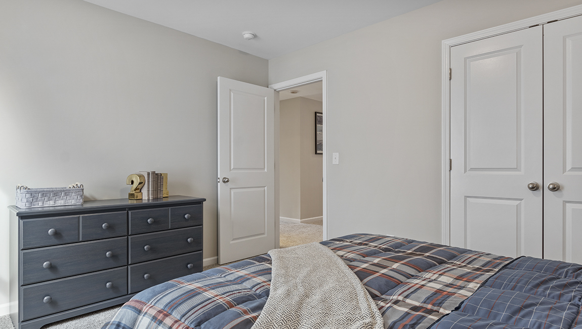 Bedroom with carpet and window.