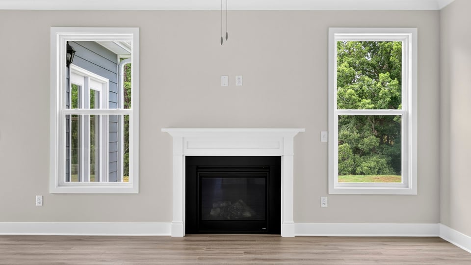 Living area with fireplace and windows.