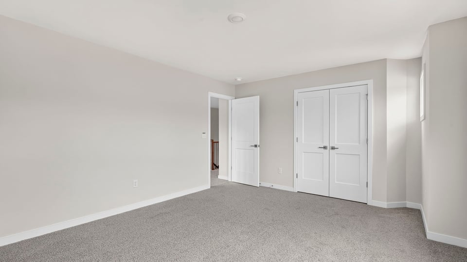 Bedroom with carpet and windows.