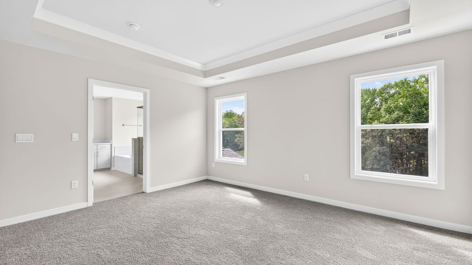 Bedroom with carpet and windows.