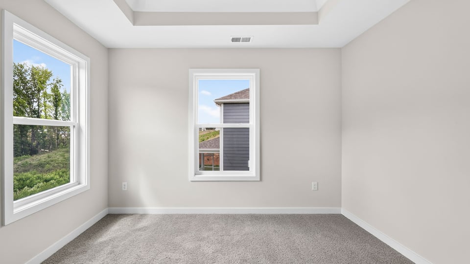 Bedroom with carpet and windows.