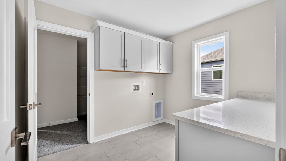 Laundry room with cabinets.