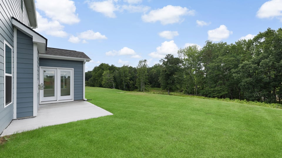 Back exterior with large backyard.