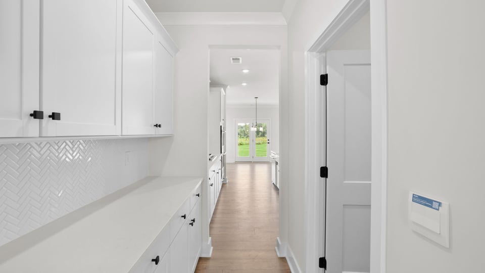 Butlers pantry with quartz countertops.