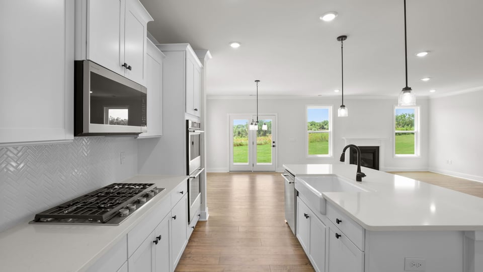 Kitchen and island with quartz countertops.