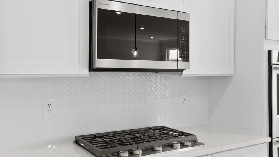 Kitchen and island with quartz countertops.