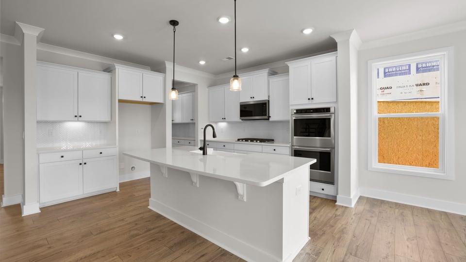 Kitchen and island with quartz countertops.