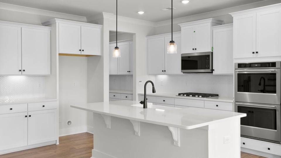 Kitchen and island with quartz countertops.