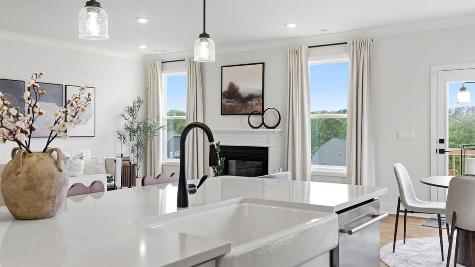 Kitchen and island with stainless steel appliances.