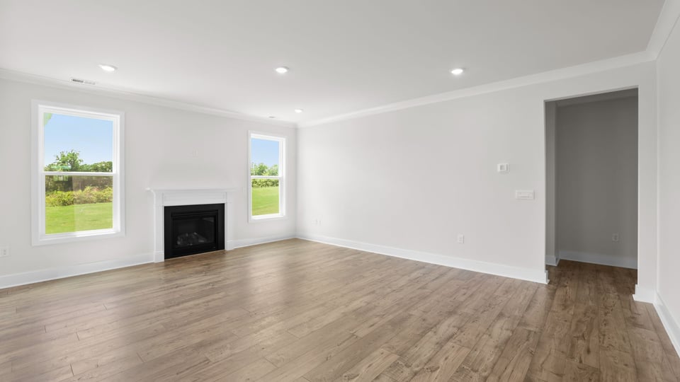 Living room with windows and fireplace.