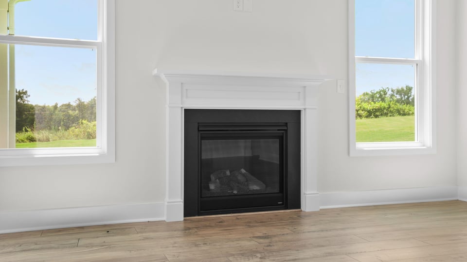 Living room with windows and fireplace.