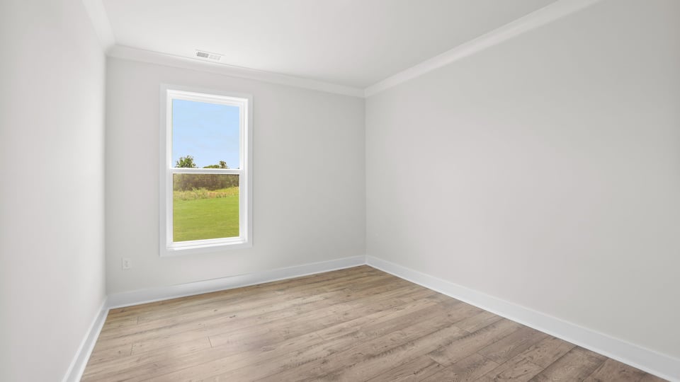 Bedroom with window and carpet.