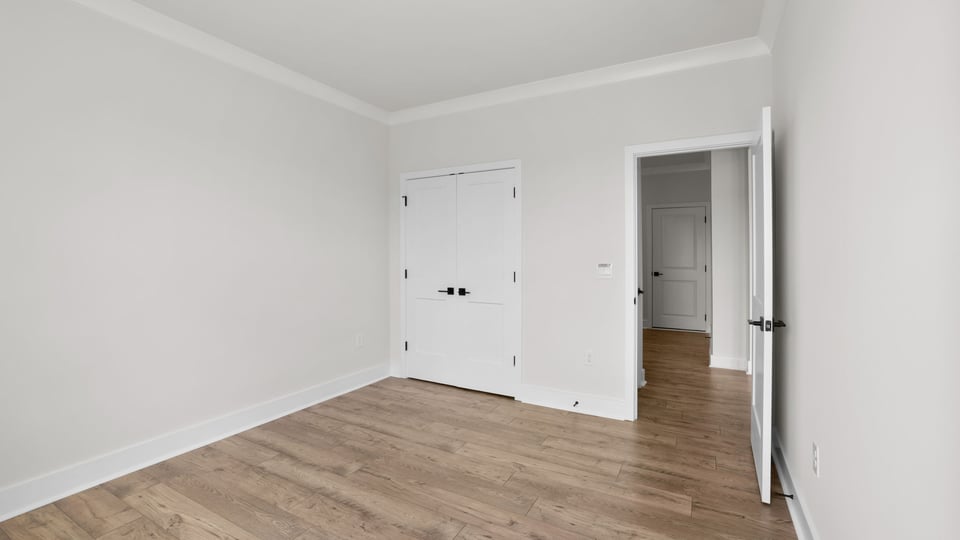 Bedroom with window and carpet.
