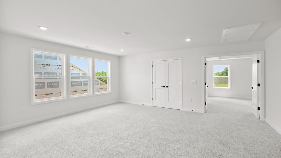 Bedroom with carpet and window.