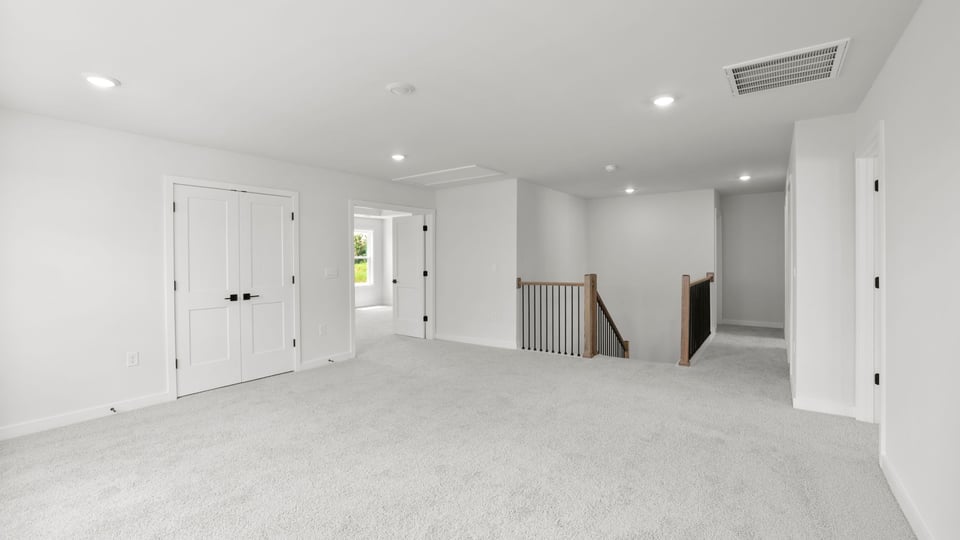 Bedroom with carpet and window.