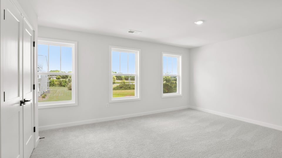 Bedroom with carpet and window.