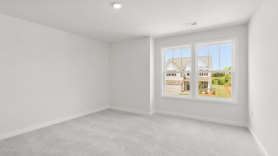Bedroom with carpet and window.