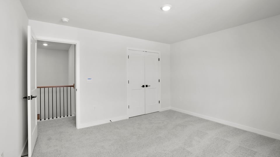 Bedroom with carpet and window.