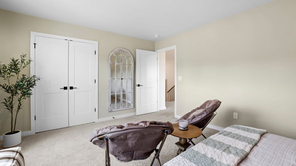Bedroom with carpet and window.