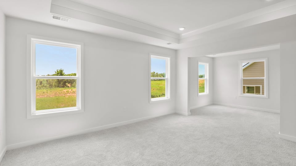 Bedroom with carpet and window.