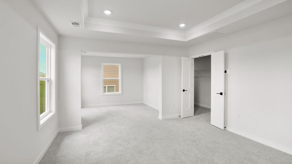 Bedroom with carpet and window.