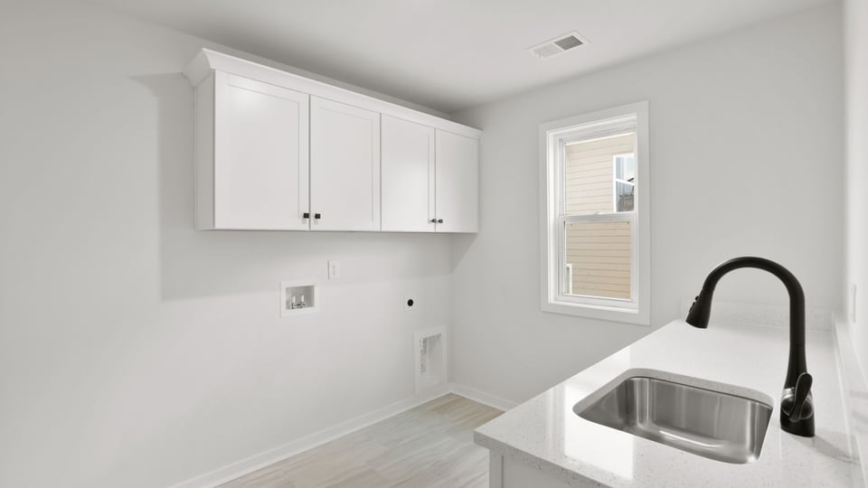 Laundry room with cabinets.