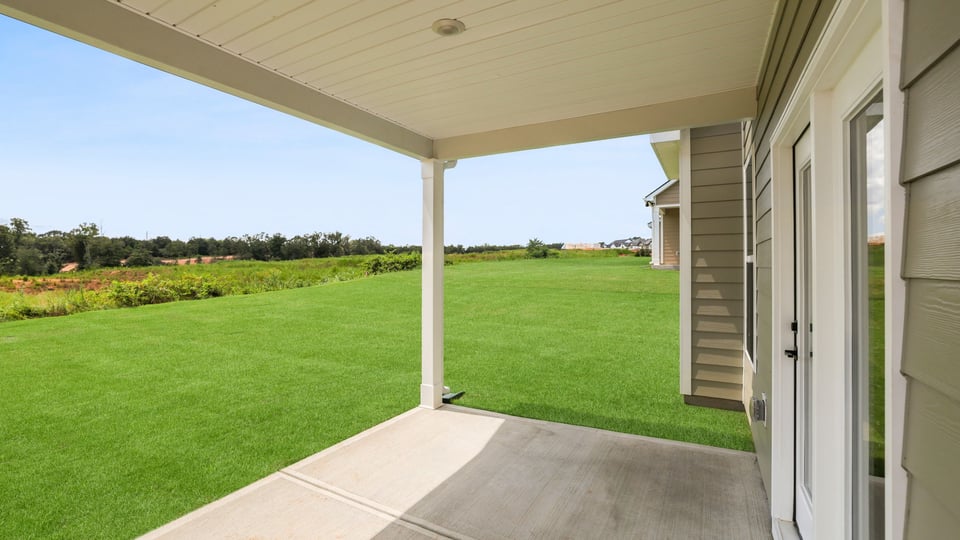 Back exterior of home with patio.