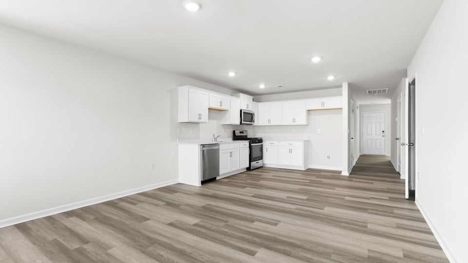 View from family room of the kitchen and hallway to the entrance.