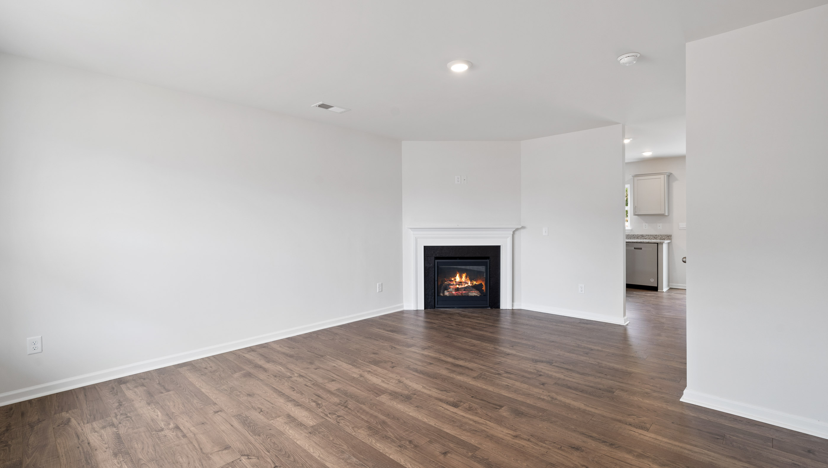 Living room with fireplace and windows.