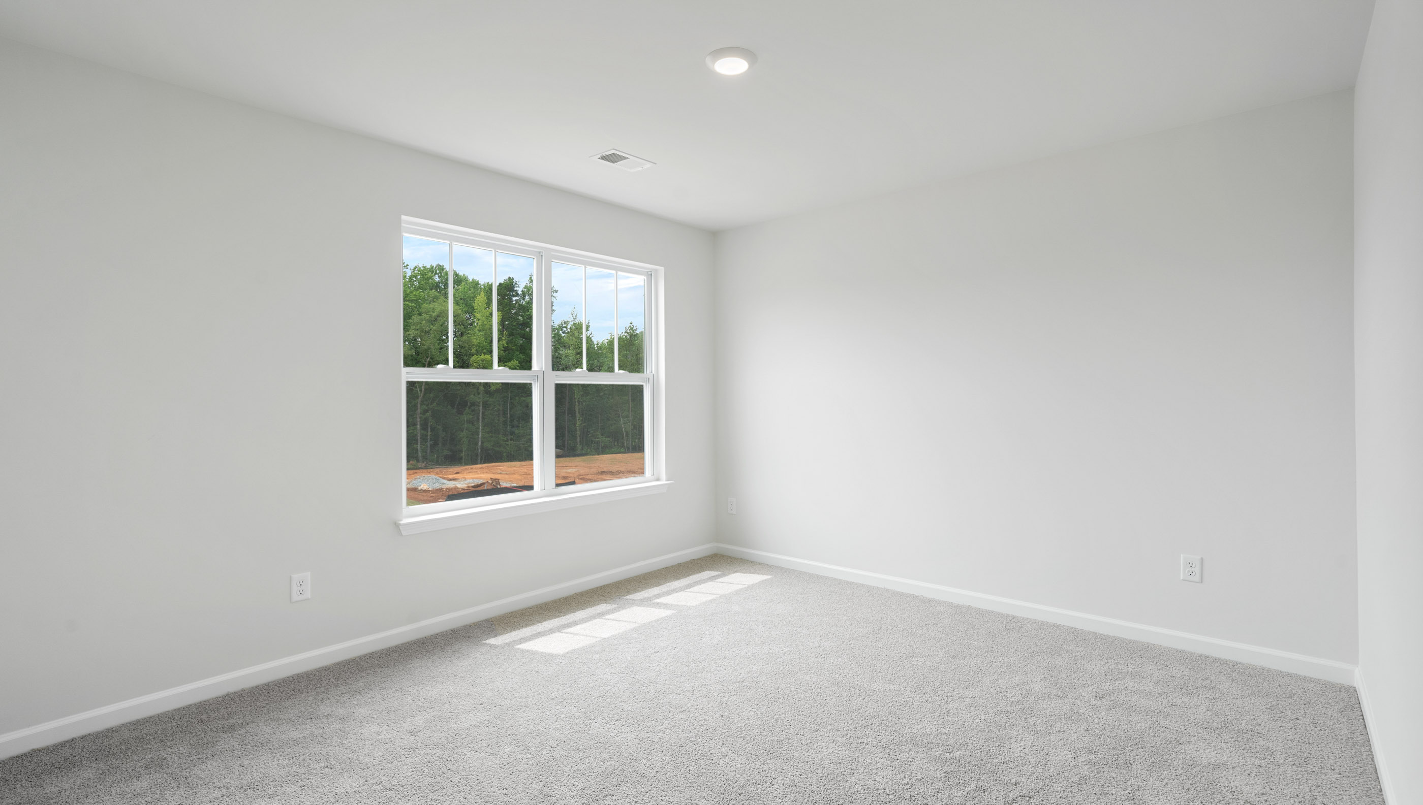 Bedroom with carpet and window.