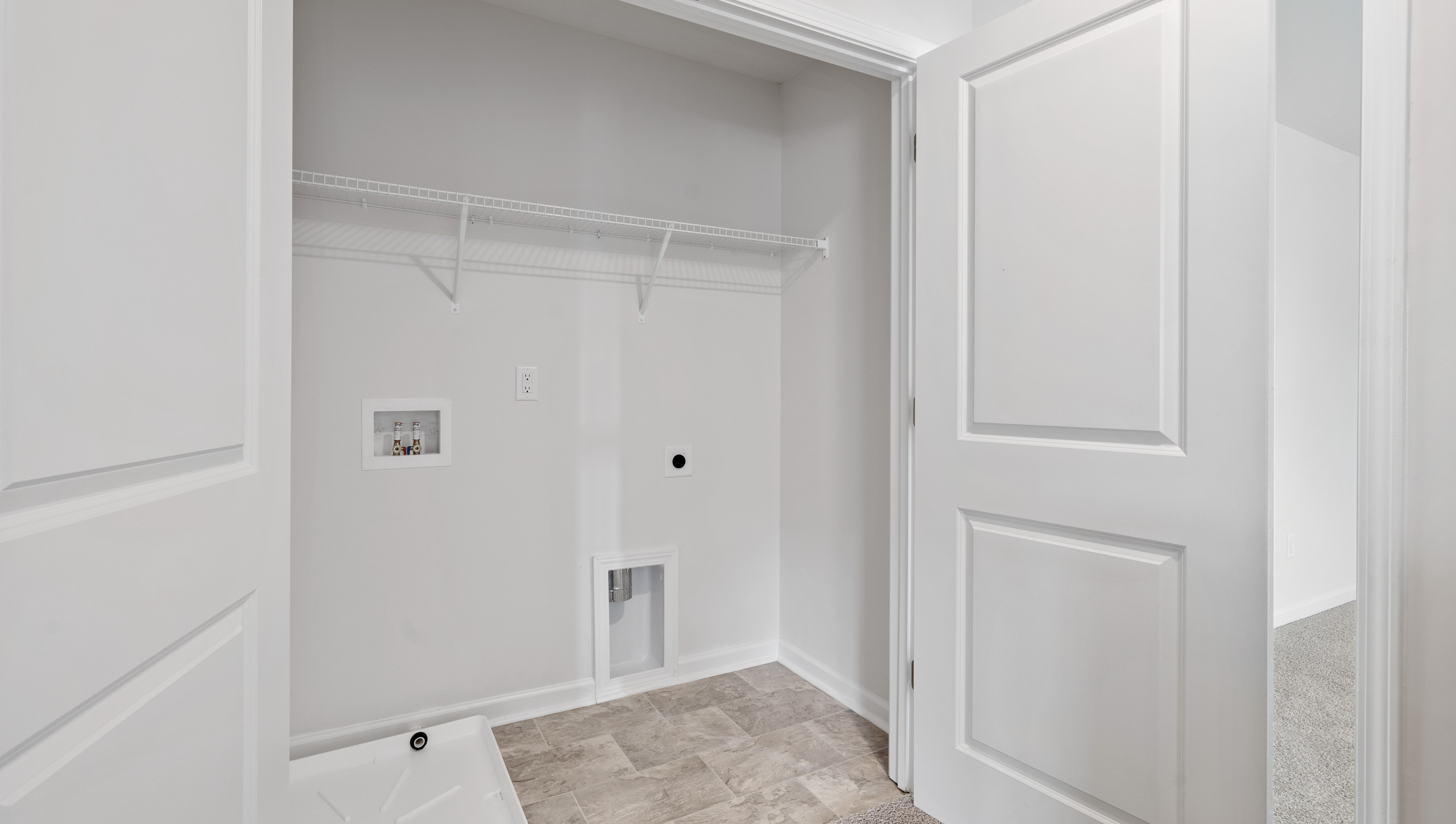 Laundry room with shelf.