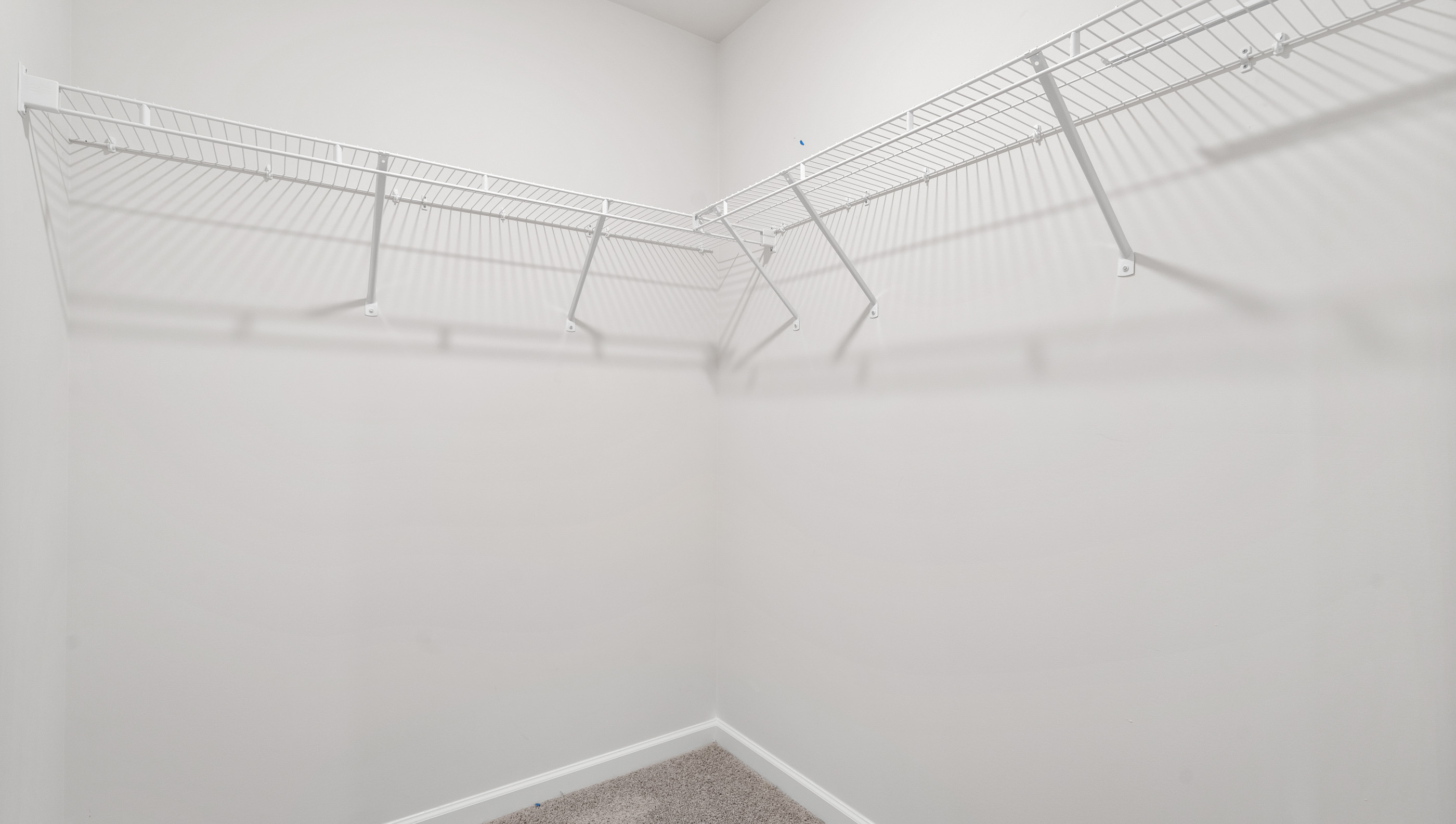 Primary closet with shelf.