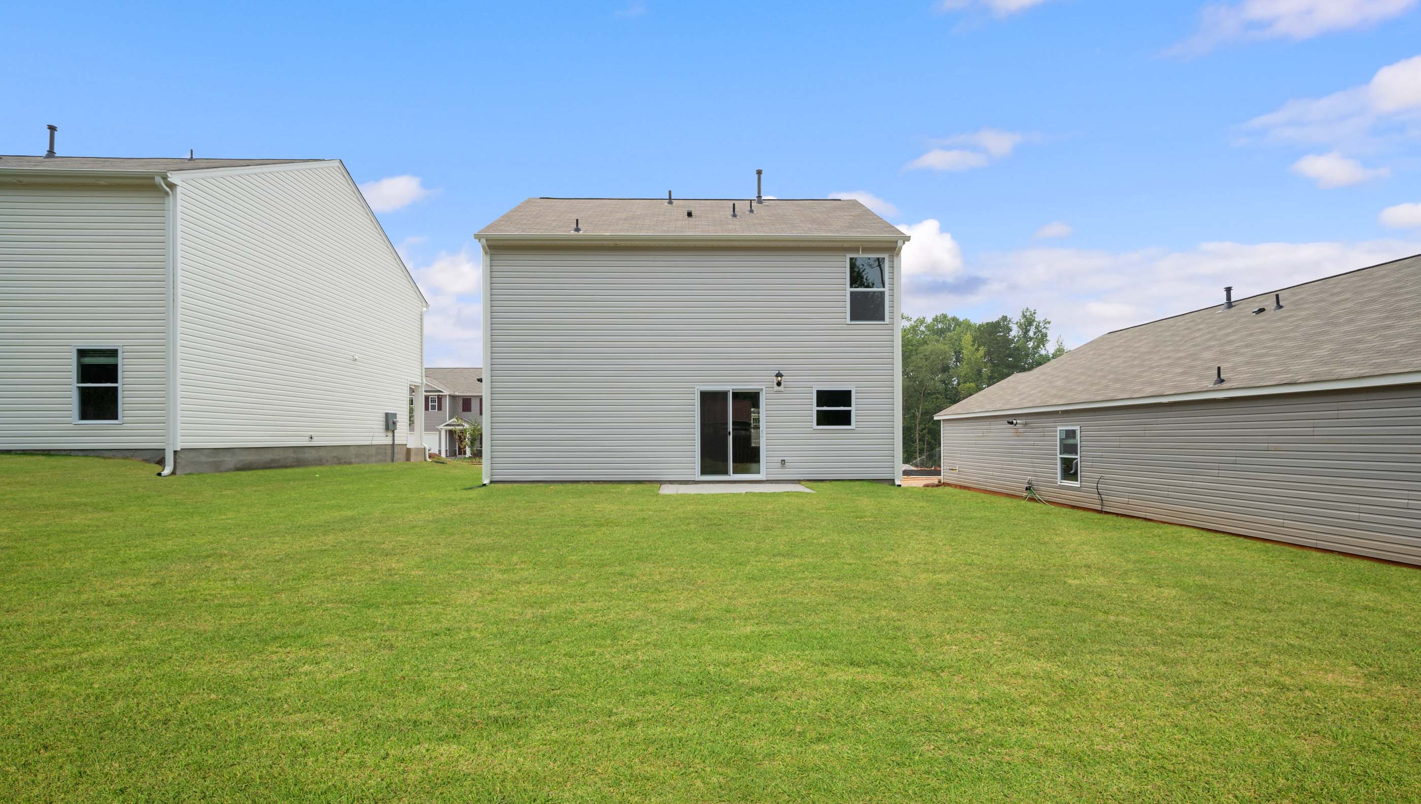 Back exterior with large backyard.
