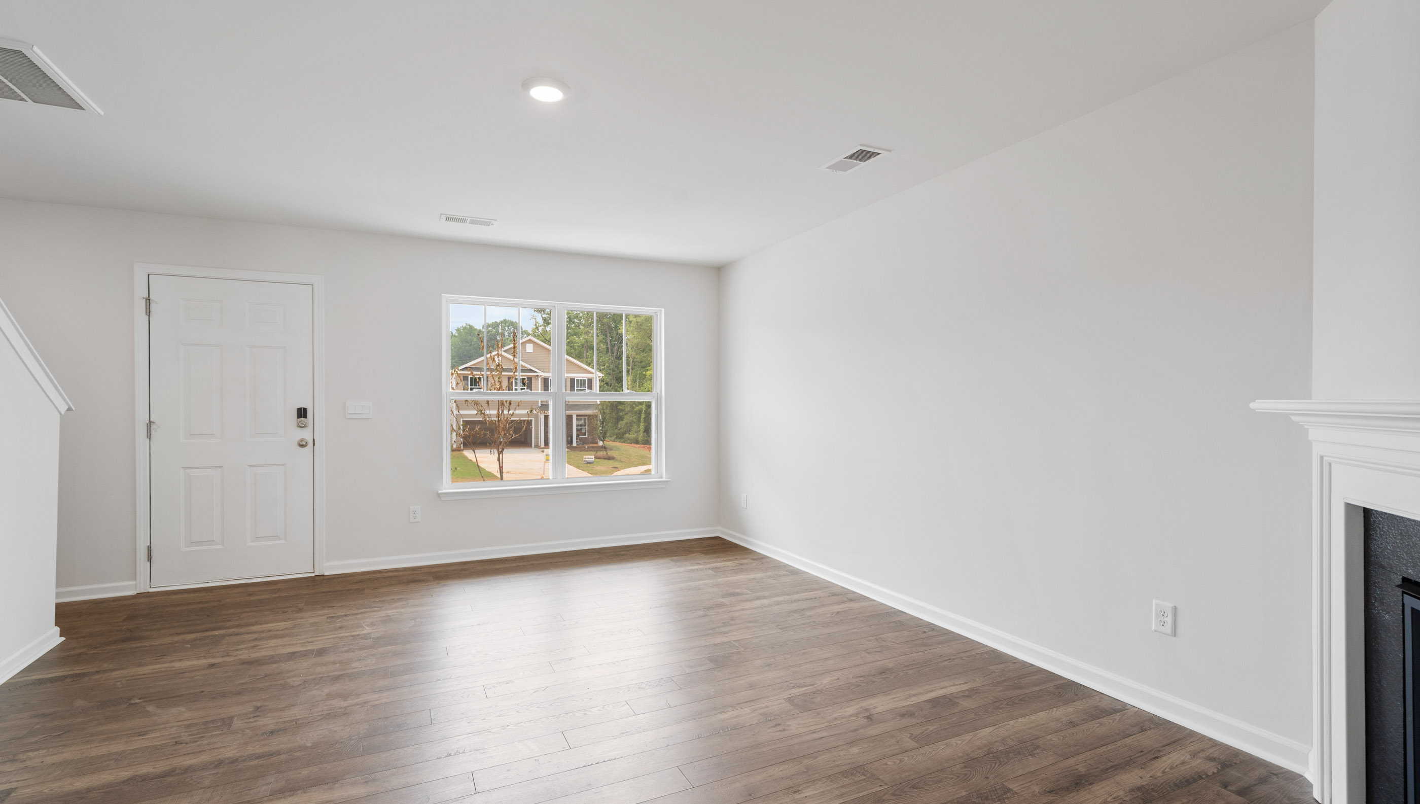 Living room with fireplace and windows.