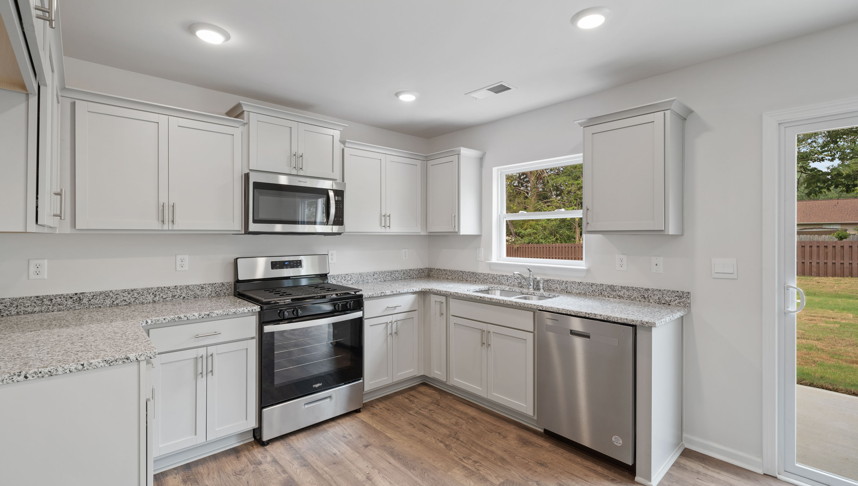 Kitchen with cabinets and windows.