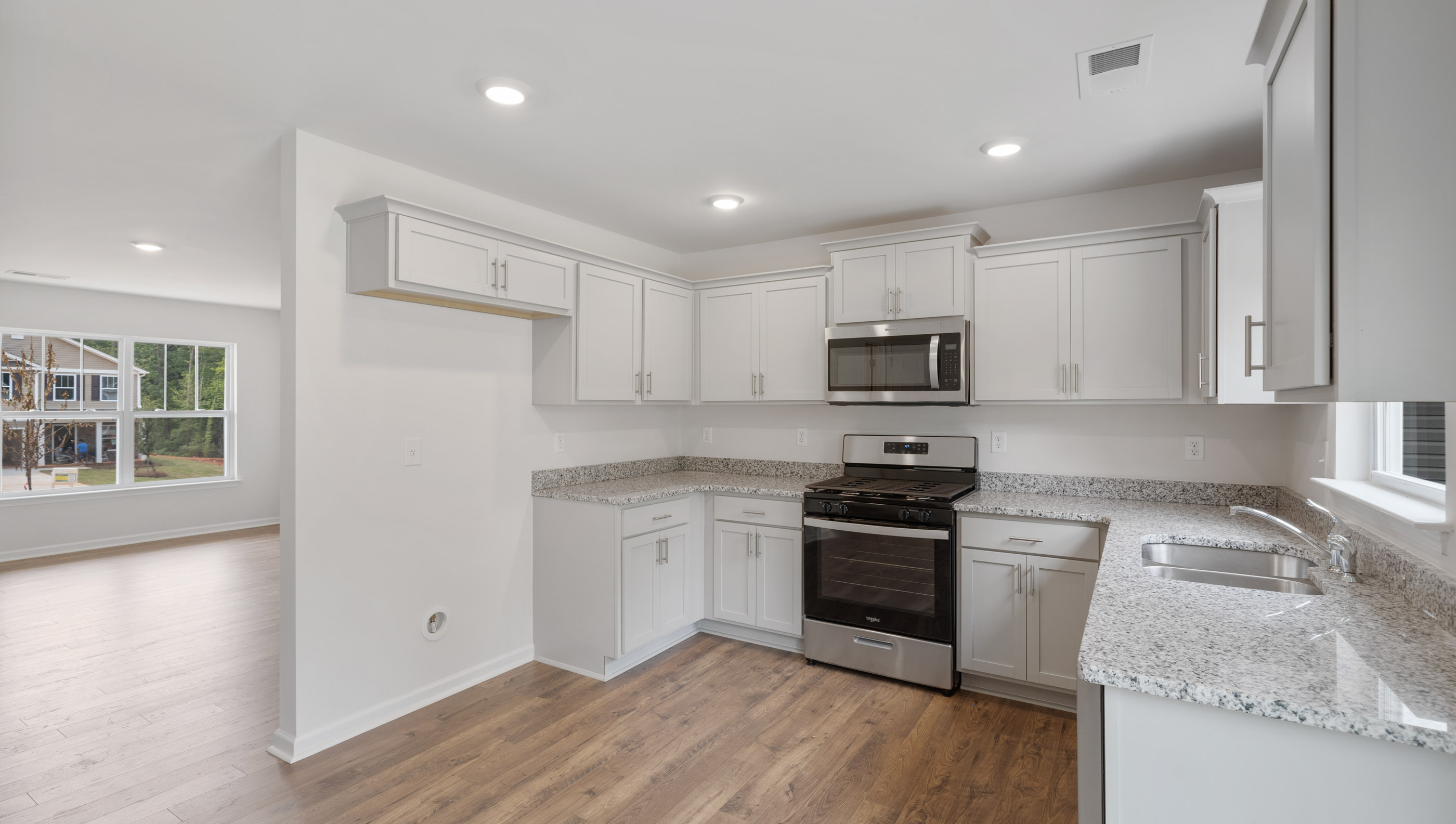 Kitchen with cabinets and windows.