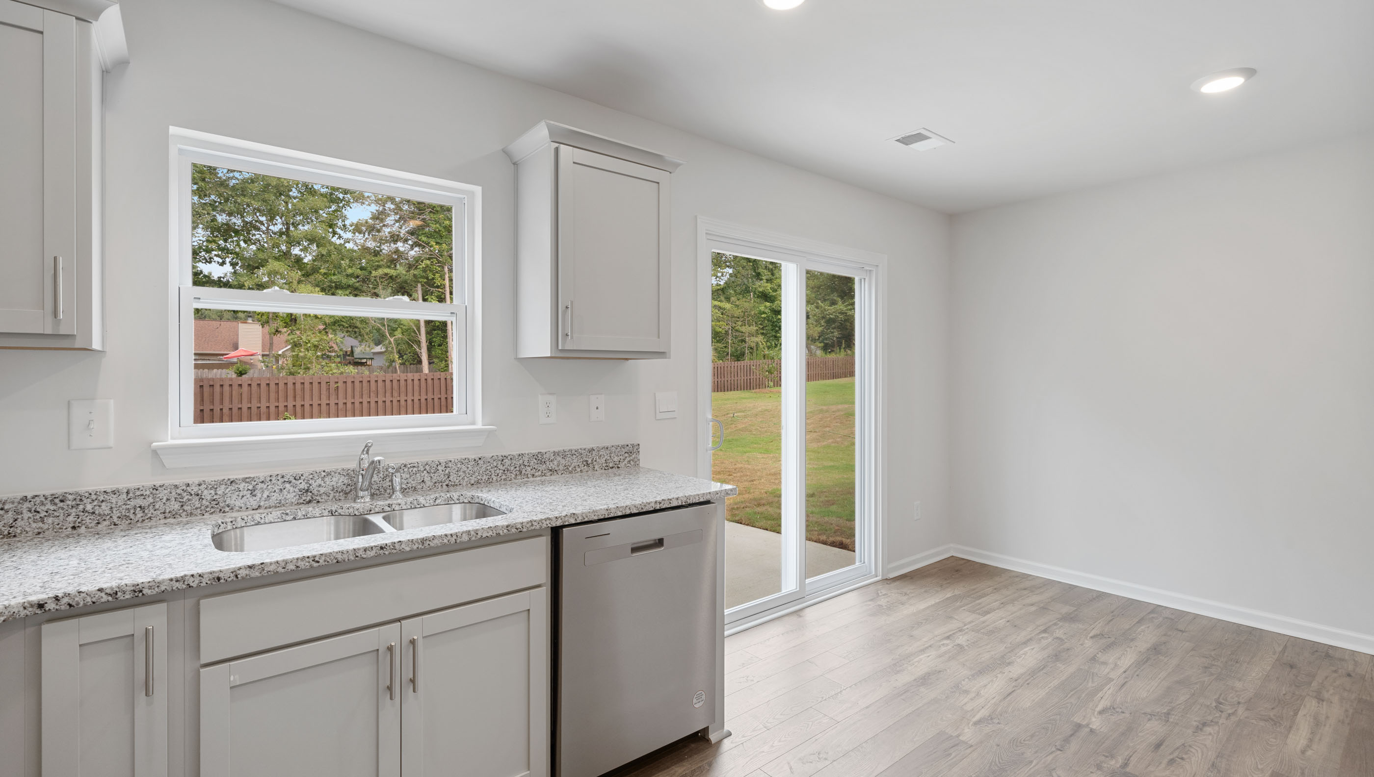 Kitchen with cabinets and windows.