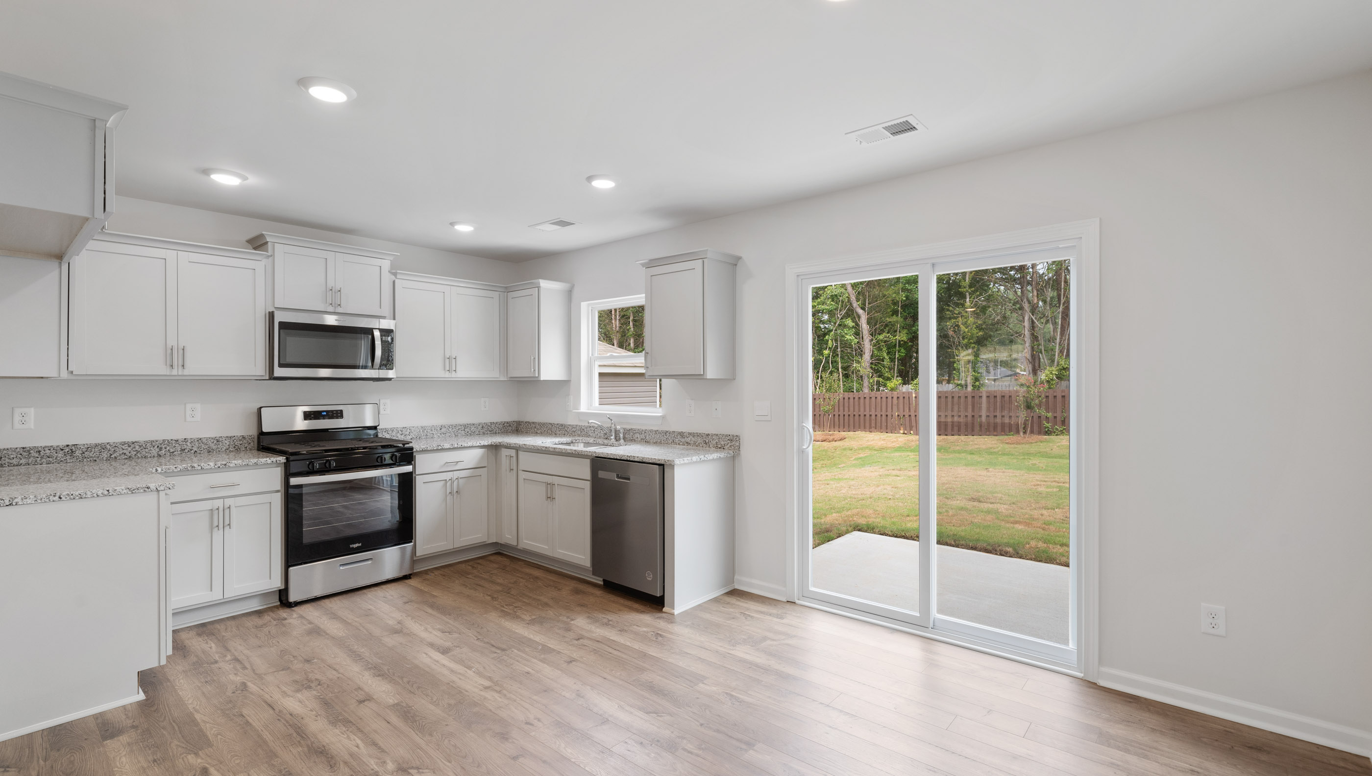 Kitchen with cabinets and windows.