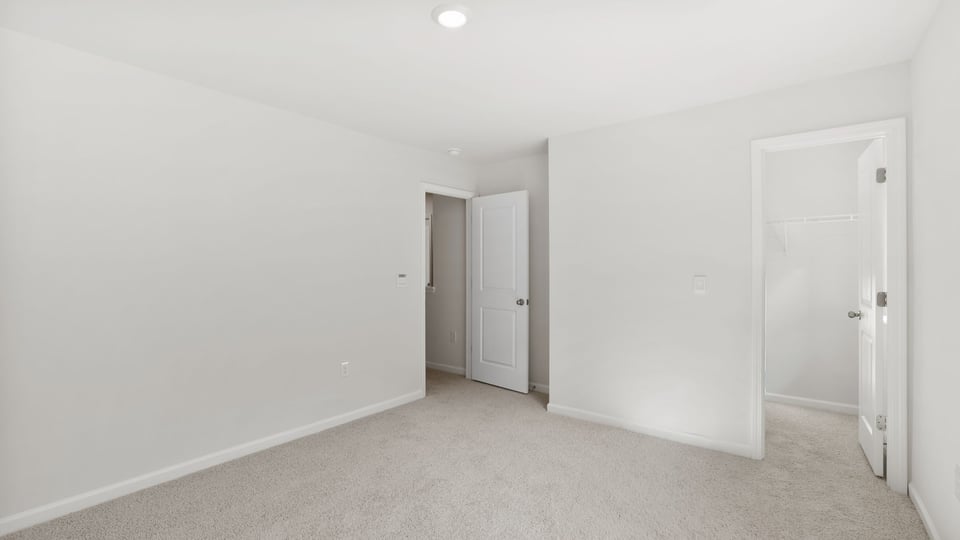 Bedroom with carpet and window.