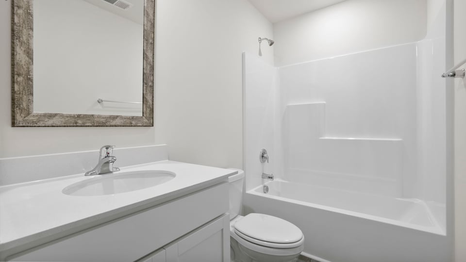 Bathroom with single vanity sink and bathtub.