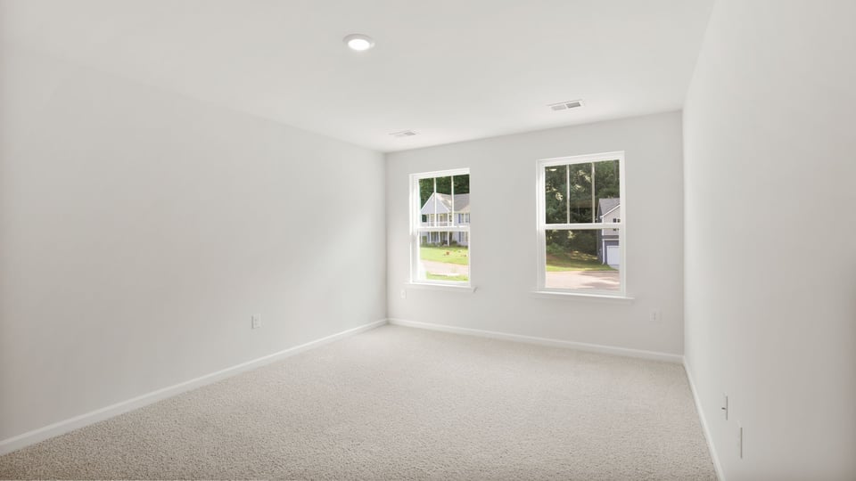 Bedroom with carpet and window.