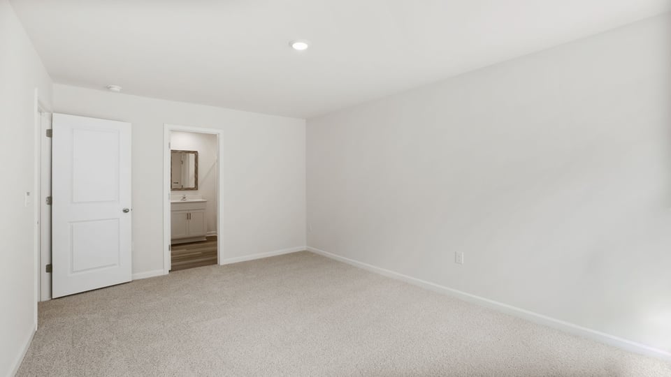 Bedroom with carpet and window.