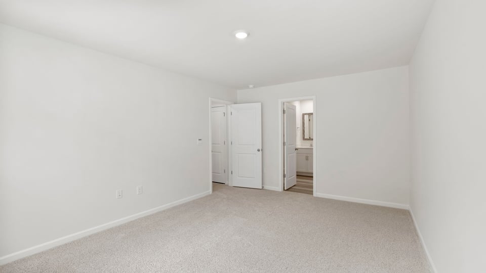 Bedroom with carpet and window.