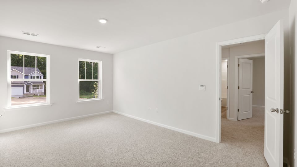 Bedroom with carpet and window.