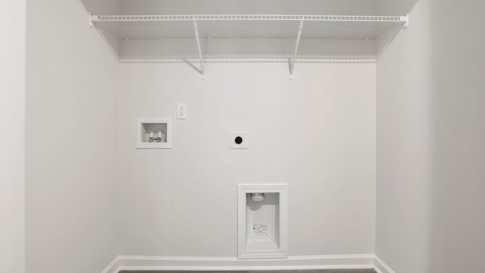 Laundry room with hanging storage racks.