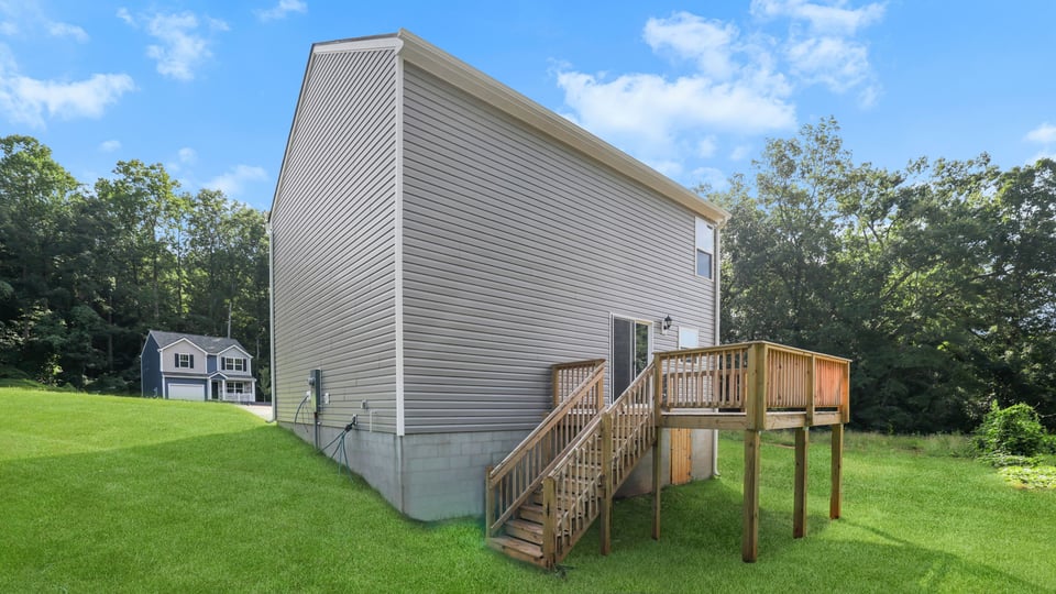 Back exterior of home with large backyard.