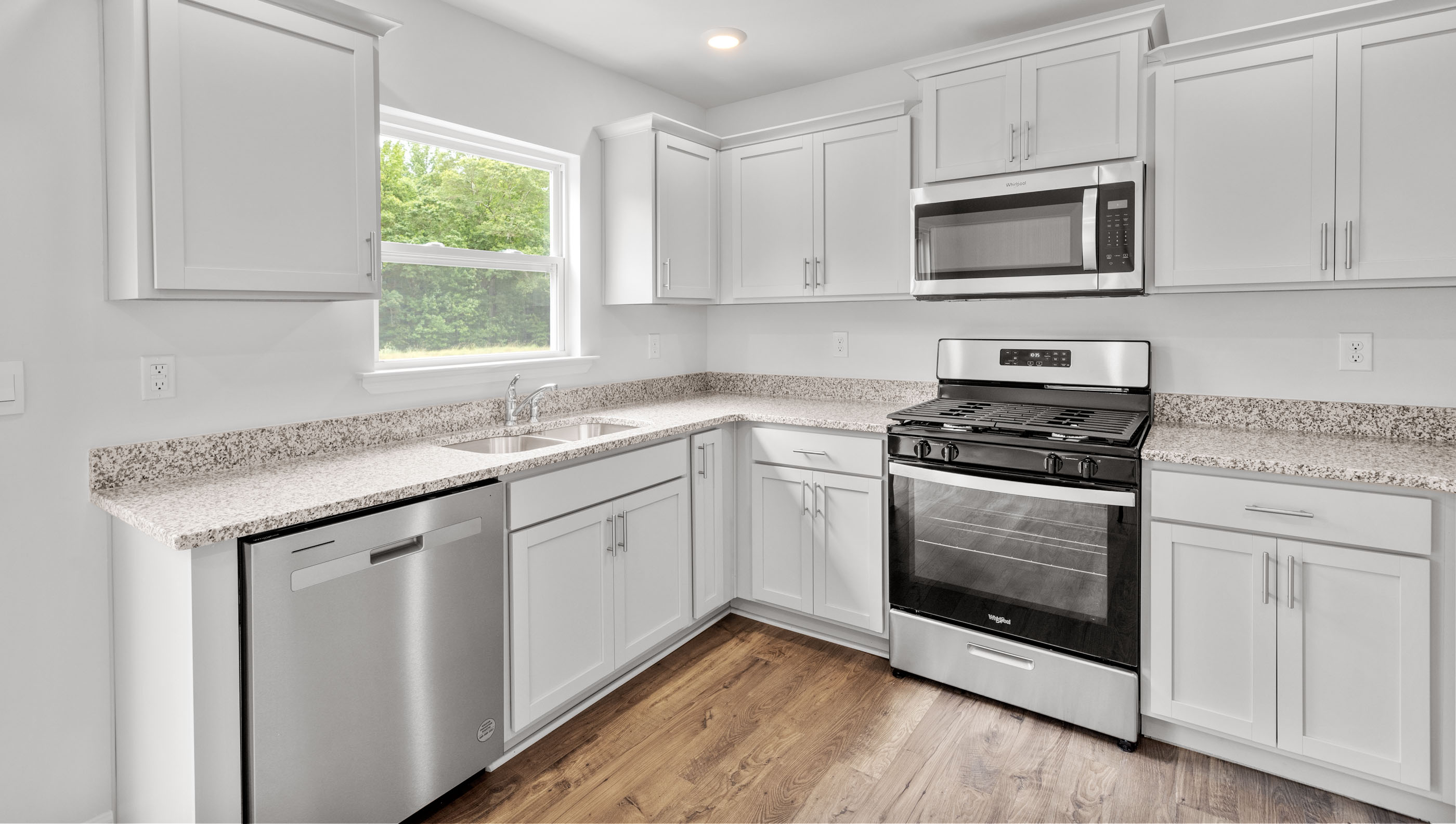 Kitchen with cabinets and windows.