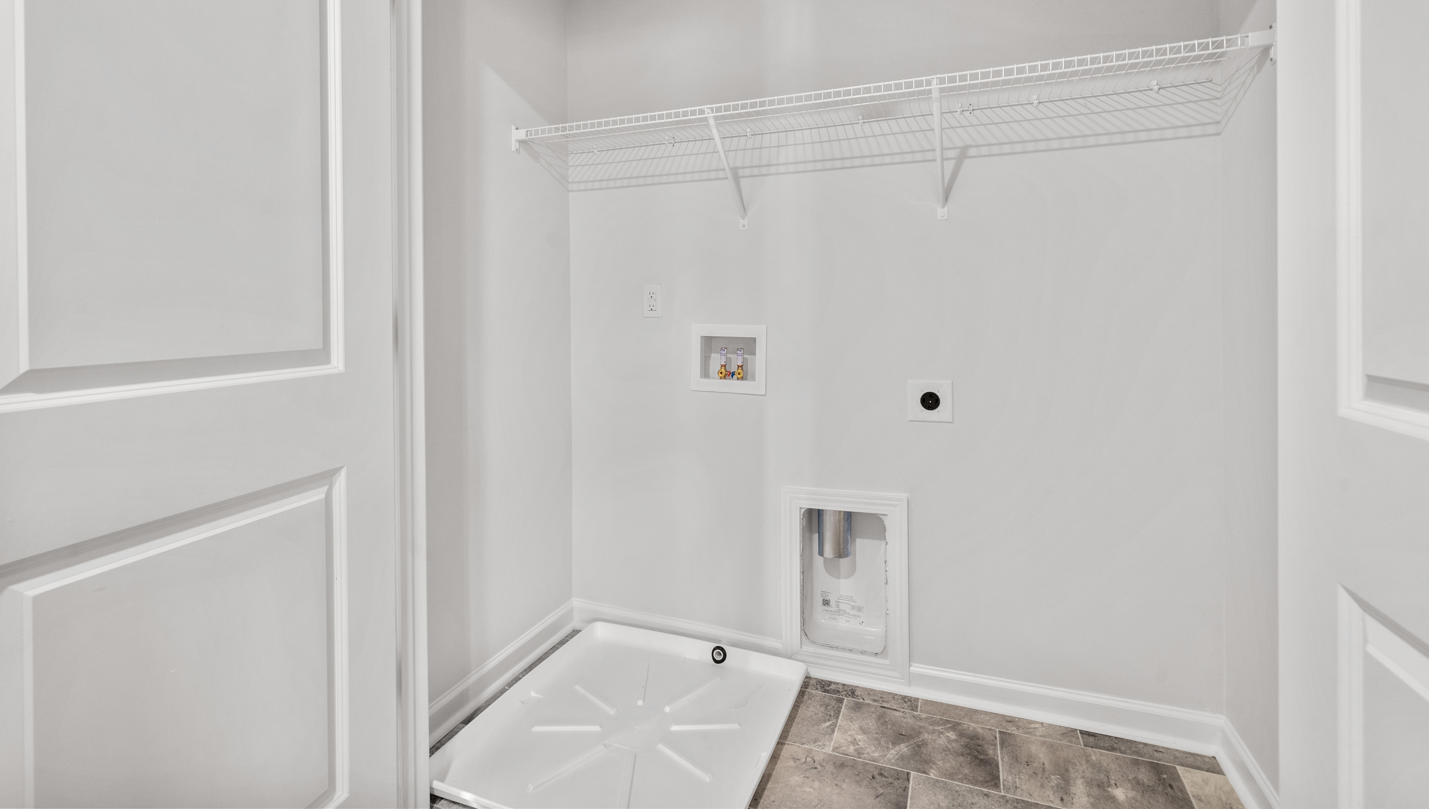 Laundry room with shelf.