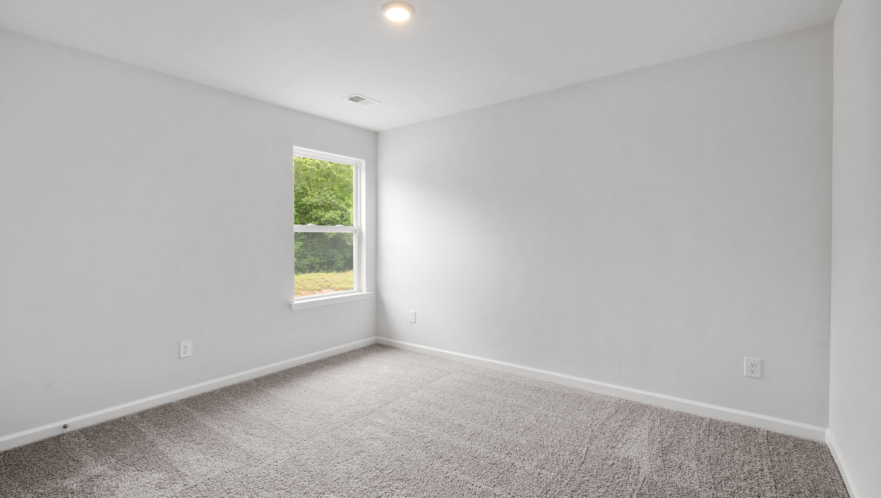 Bedroom with carpet and window.